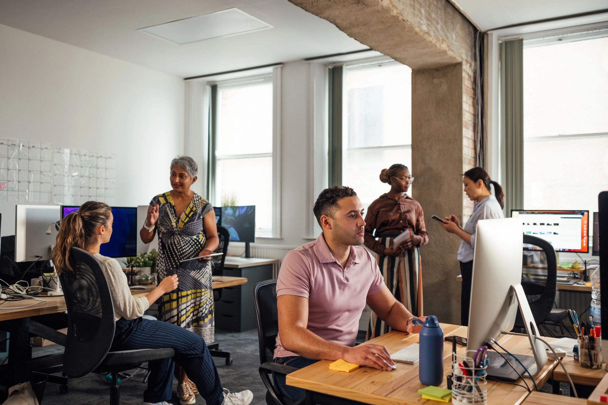 Office team collaborating at desks